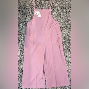 Women’s purple romper with pockets, adjustable straps, size large.
